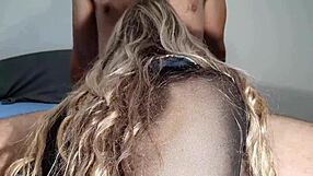 Cute girl rides big cock while sucking it eagerly.