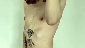 The tattooed transsexual slut jerks her cock in a solo masturbation session