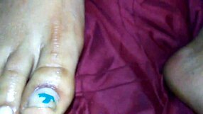 An ebony woman gives a footjob, leading to a cumshot on her feet.