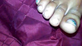 An ebony woman gives a footjob, leading to a cumshot on her feet.