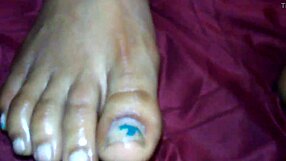 An ebony woman gives a footjob, leading to a cumshot on her feet.