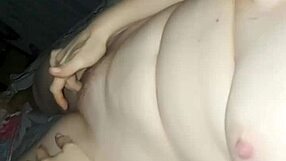 The wife experiences a double orgasm while playing with her boobs in the bedroom.