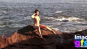 Hot brunette babe in lingerie masturbates pussy on beach, reaching orgasm with lesbian sucking