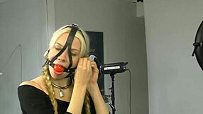 Bound in bondage, the submissive wears a ball gag harness, part 01 of the BDSM session.