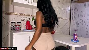 Pregnant housewife in kitchen sheer