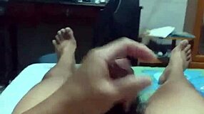 lying on bed, stroking cock with intense pleasure until spraying cum