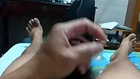 lying on bed, stroking cock with intense pleasure until spraying cum