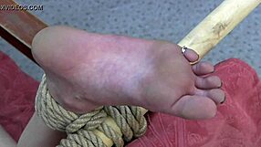 Bound woman with bare feet in bondage