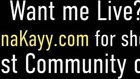 riley gently covers nina kayy's chest while they relax on the sofa