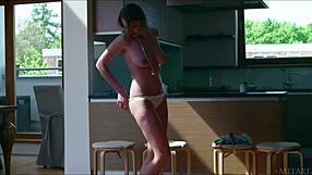 busty russian babe ethelle undresses in softcore solo scene.