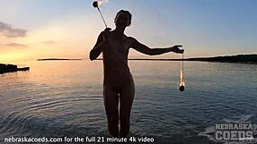 beautiful glamour model rehearsing fire show on the editorial photoshoot shoot on the seashore