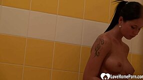 brunette with tattoos has a nice shower