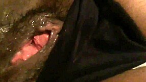 Her wet pussy glistened as she teased herself in solitude.