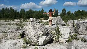 Topless mature lady dances seductively in stone quarry