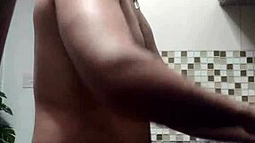 macho guy bent over washing dishes, with a suggestive twist