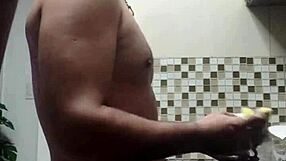 macho guy bent over washing dishes, with a suggestive twist