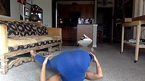 Ginger Mistress teases in blue, nipples exposed, smiles while licking herself