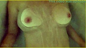 In the hotel bath, the wife gets wet, showcasing her big tits