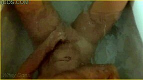 In the hotel bath, the wife gets wet, showcasing her big tits