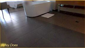 In the hotel bath, the wife gets wet, showcasing her big tits