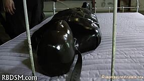 Bound in tight bondage, the submissive endures sadomasochistic pleasures with ropes and restraints