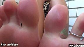 Watch how she works a big dildo with footjob and handjob.