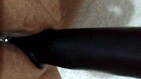 wife playfully using dildo at home