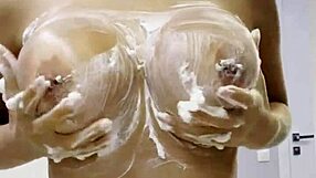 Monika Fox strips naked at home, rubbing cream over her big fake tits and curvy butt in solo tease