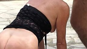 Mature amateurs passionately making love in the garden.