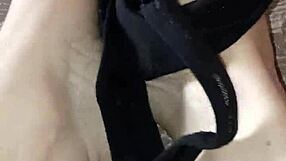 Gretala suggestively rubs her thong on her bare feet.