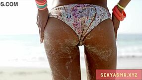 Is that beach hottie in bikini teasing her ass?