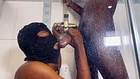 She drops to her knees to deepthroat the monster cock eagerly. Then he bends her against the wall for intense doggystyle pounding until orgasm.