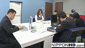 The Asian secretary experiences teasing touches during her phone call. She reacts with surprise.