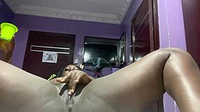 Chubby ebony mature lies on the bed for a wet solo masturbation session in her room