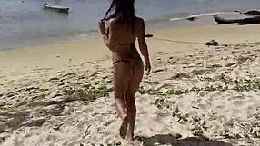 Monika Fox poses solo in pink bikini with stars on the beach showing big fake tits free