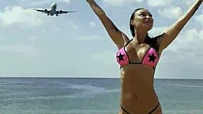 Monika Fox poses solo in pink bikini with stars on the beach showing big fake tits free