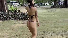 Monika Fox poses solo in pink bikini with stars on the beach showing big fake tits free