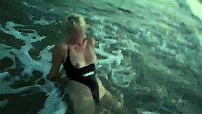 blonde shows tits and sucks cock on a public beach with brunette watching