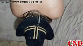 In the dorm, the Brazilian girlfriend bends over on the bed as the husband watches her scream during intense action