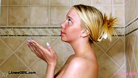 Elegant shy blonde steps into steamy shower gracefully