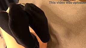 Japanese femdom babe in costume punishes slave with footjob licks socks and toes before cumshot