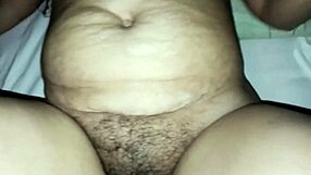 young desi bride gives husband footjob massage with toes on ankles in bedroom