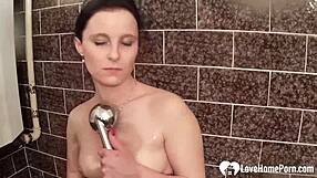 beautiful girlfriend fingers her shaved pussy to orgasm in the shower