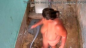hidden cam catches busty stepmom bathing and flashing huge tits outside