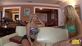 Two gorgeous blondes kissing licking on the sofa