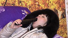 Mature brunette milf sucks huge dildo in furry hood coat positions