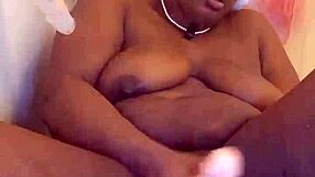 Black milf bares shaved pussy tease