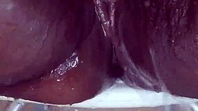 Black milf bares shaved pussy tease
