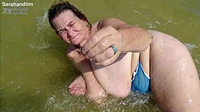 curvy granny with huge saggy tits and plump ass fingers trimmed pussy on beach close-up