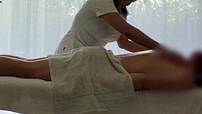 Asian babe oils caucasian cock for massive handjob cum explosion